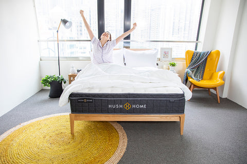 woman stretching in the morning with her weighted blanket